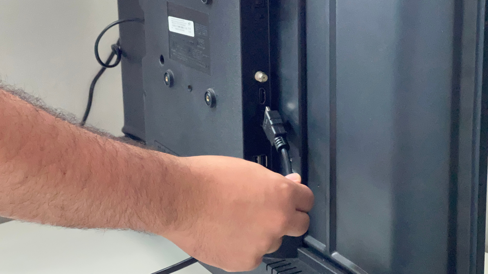 Removendo cabos HDMI e dispositivos TV Box da traseira da televisão